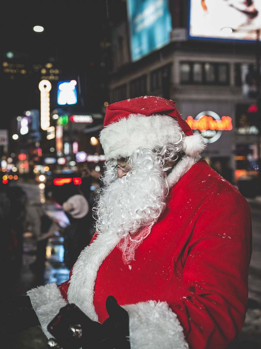 festive Santa Claus standing near buildings santa