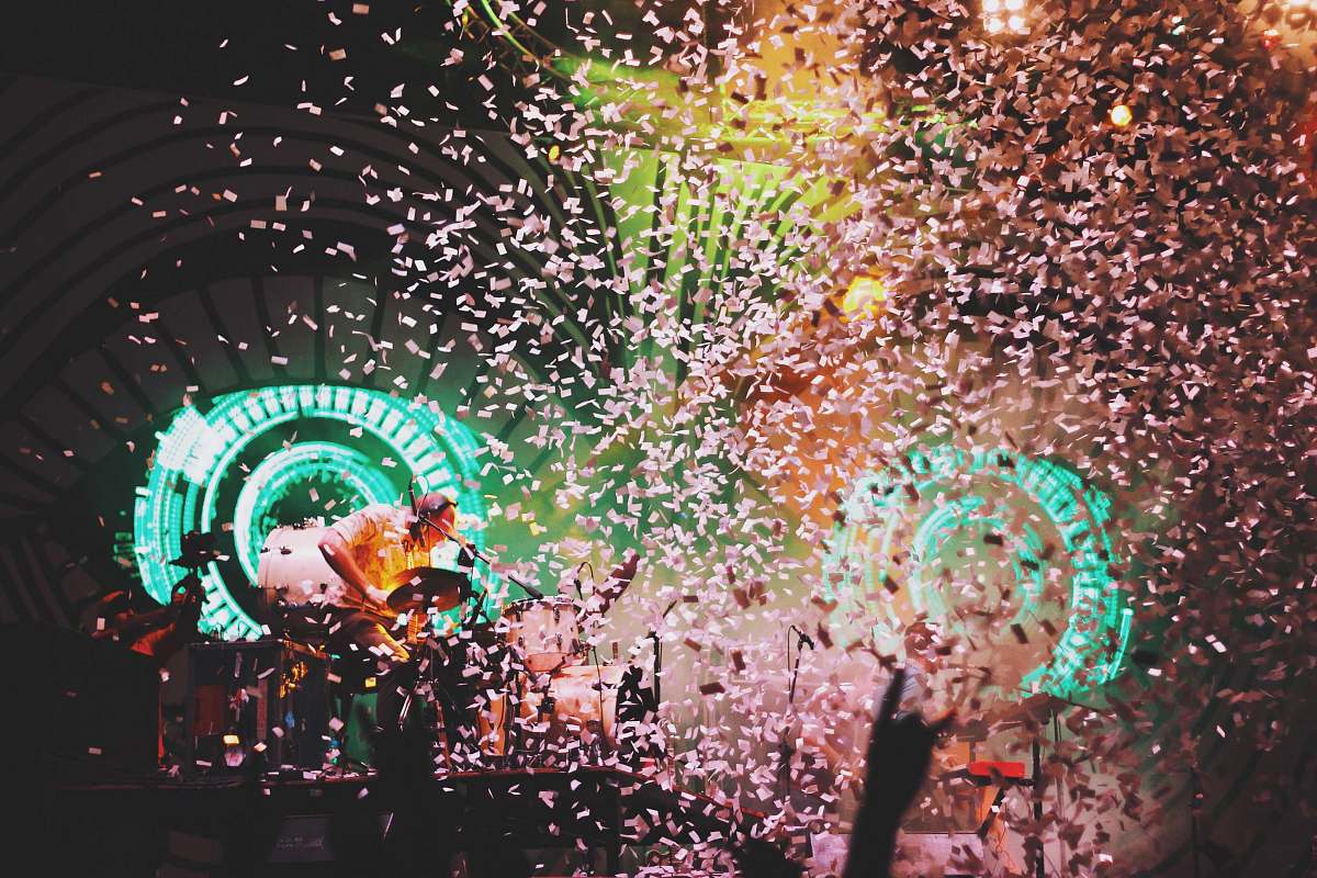 concert pink confetti dropping on lighted stage india