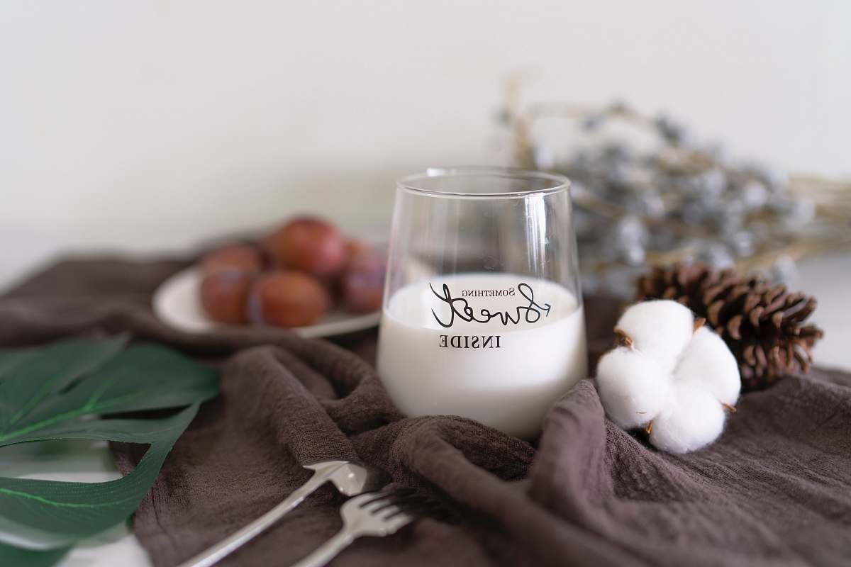 brown white liquid in glass cup milk