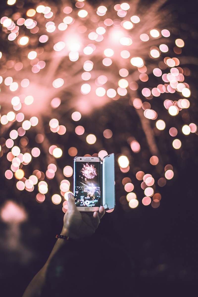 moody person taking video of pink firework display solinea resort condominium by alveo land