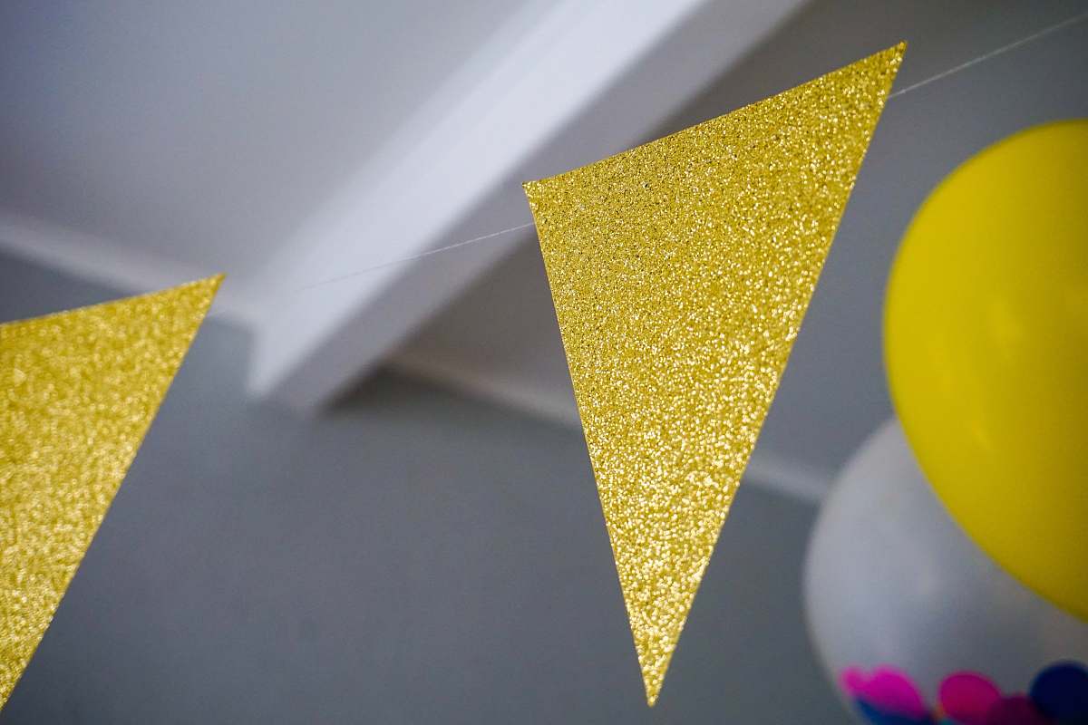 triangle yellow glitter buntings hanging inside room confectionery