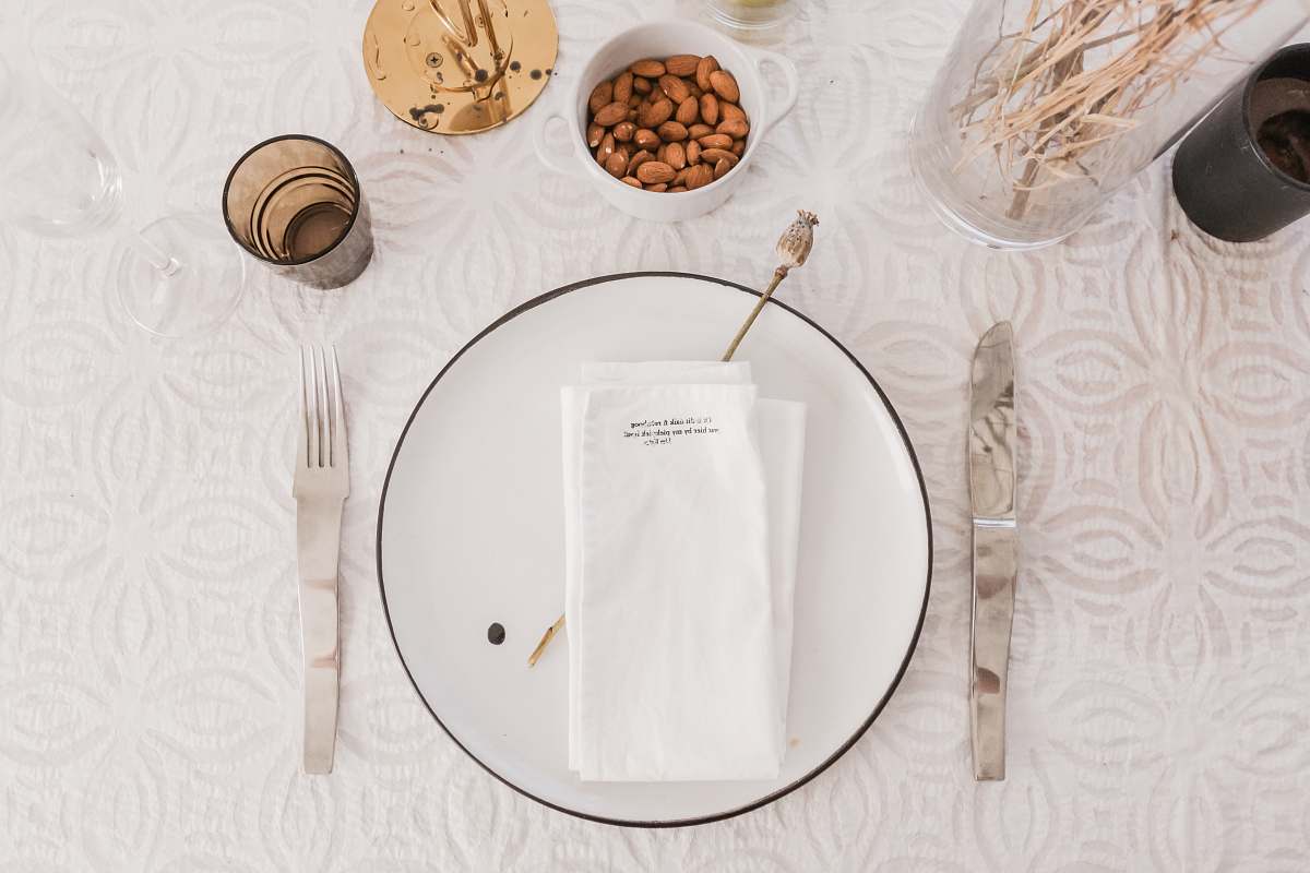 hands aerial photography of plate on table glasses