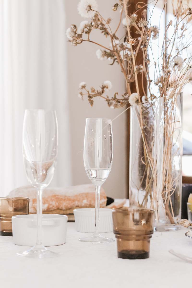goblet champagne glasses beside flower centerpiece table