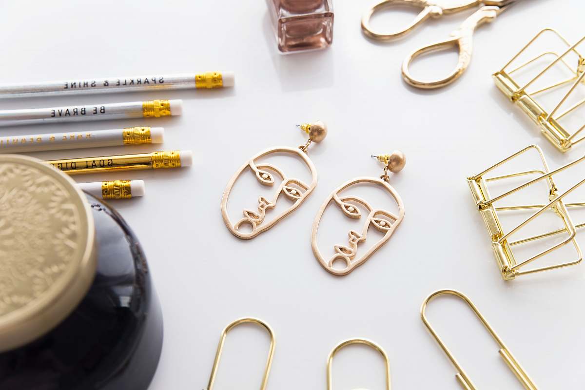 weaponry gold-colored face-cutout earrings weapon
