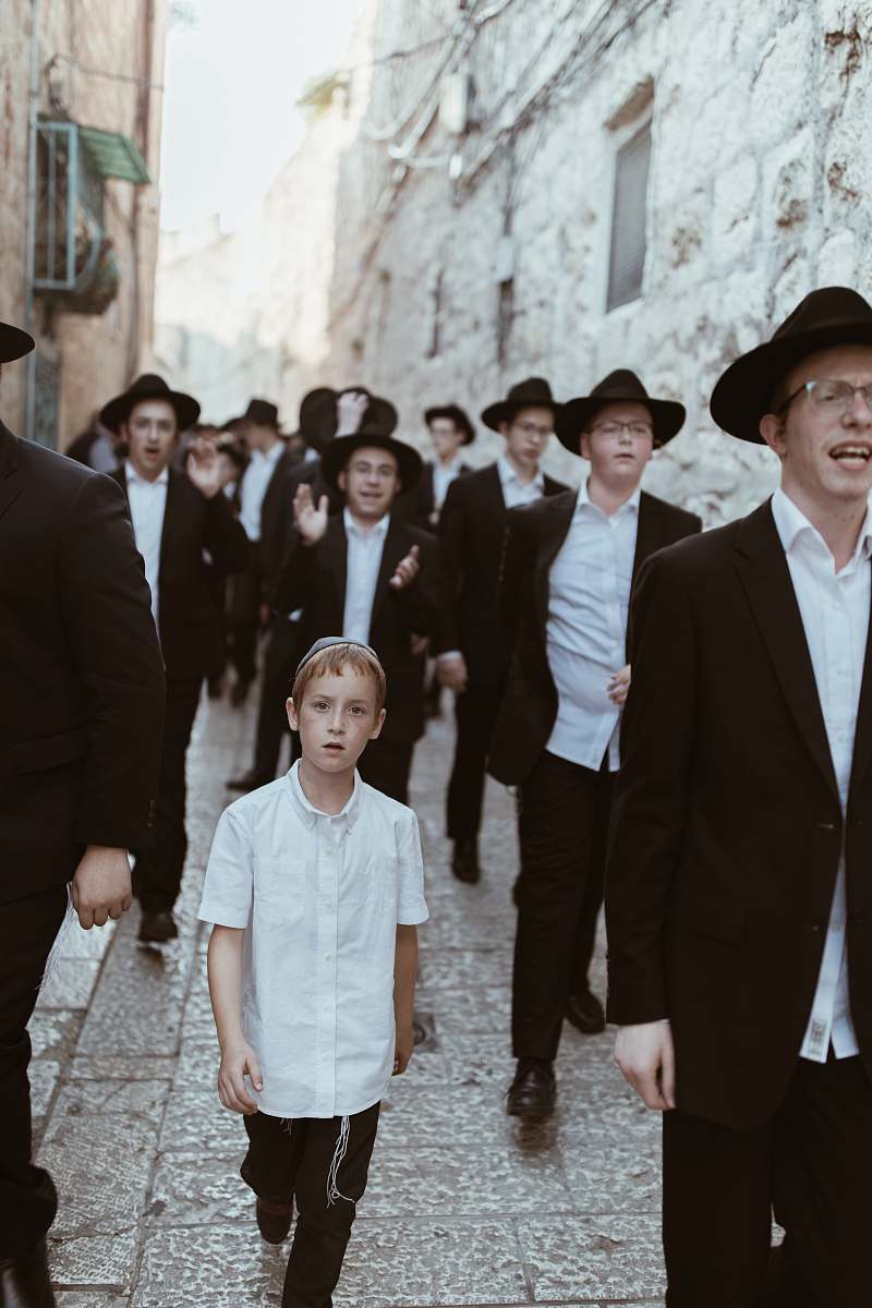 people group of men walking on concrete road suit