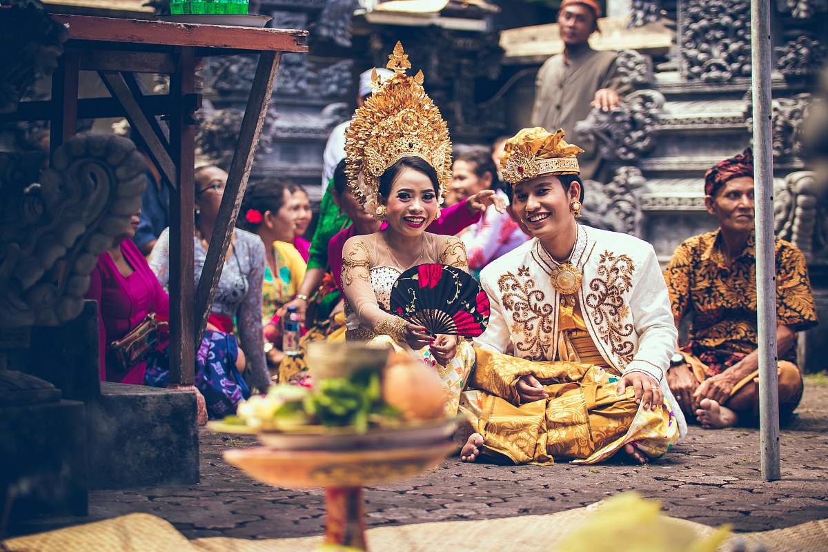 person man and woman sitting on area rug smiling people
