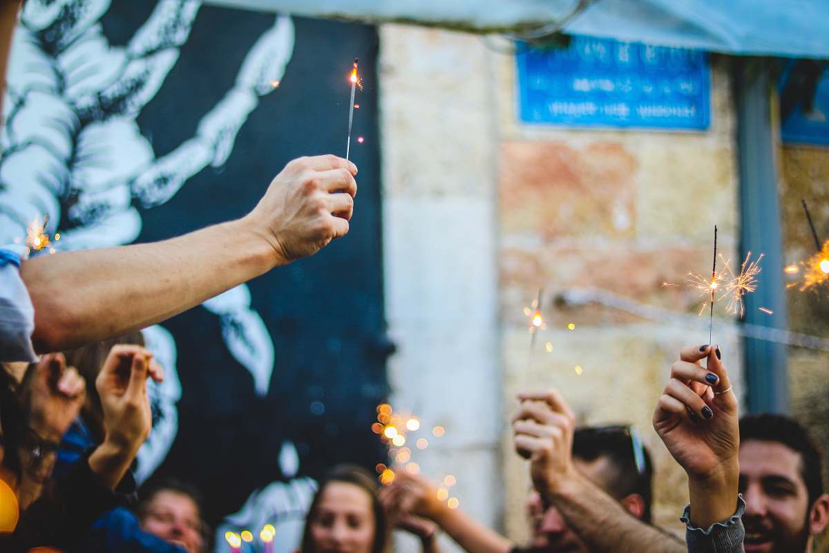 person people holding firecracker sticks finger