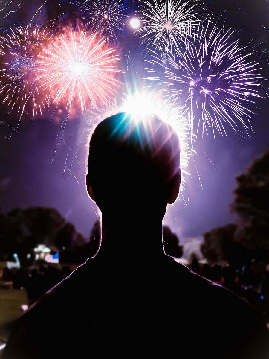 fireworks person looking at fireworks display night