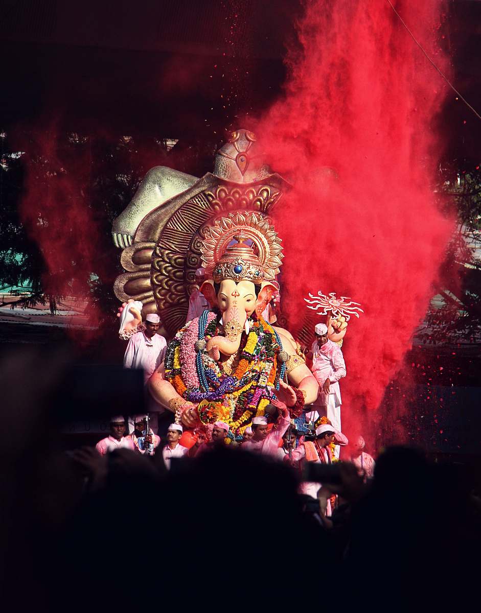 person Ganesha statue surrounded by people human