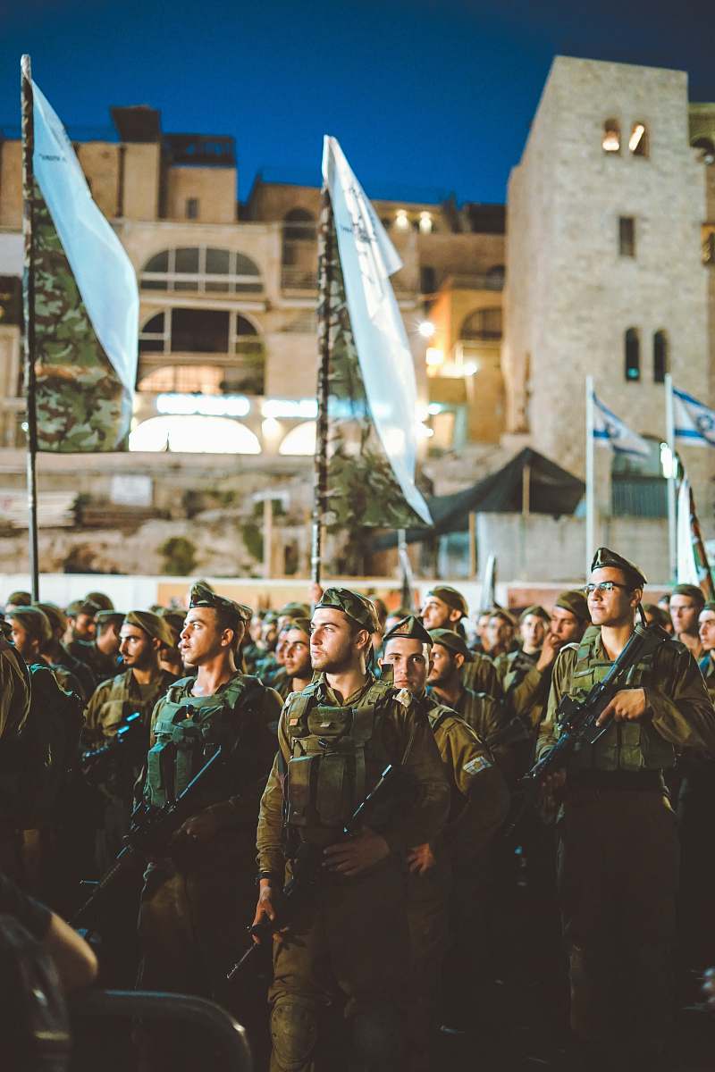 human group of armed men with white flag person