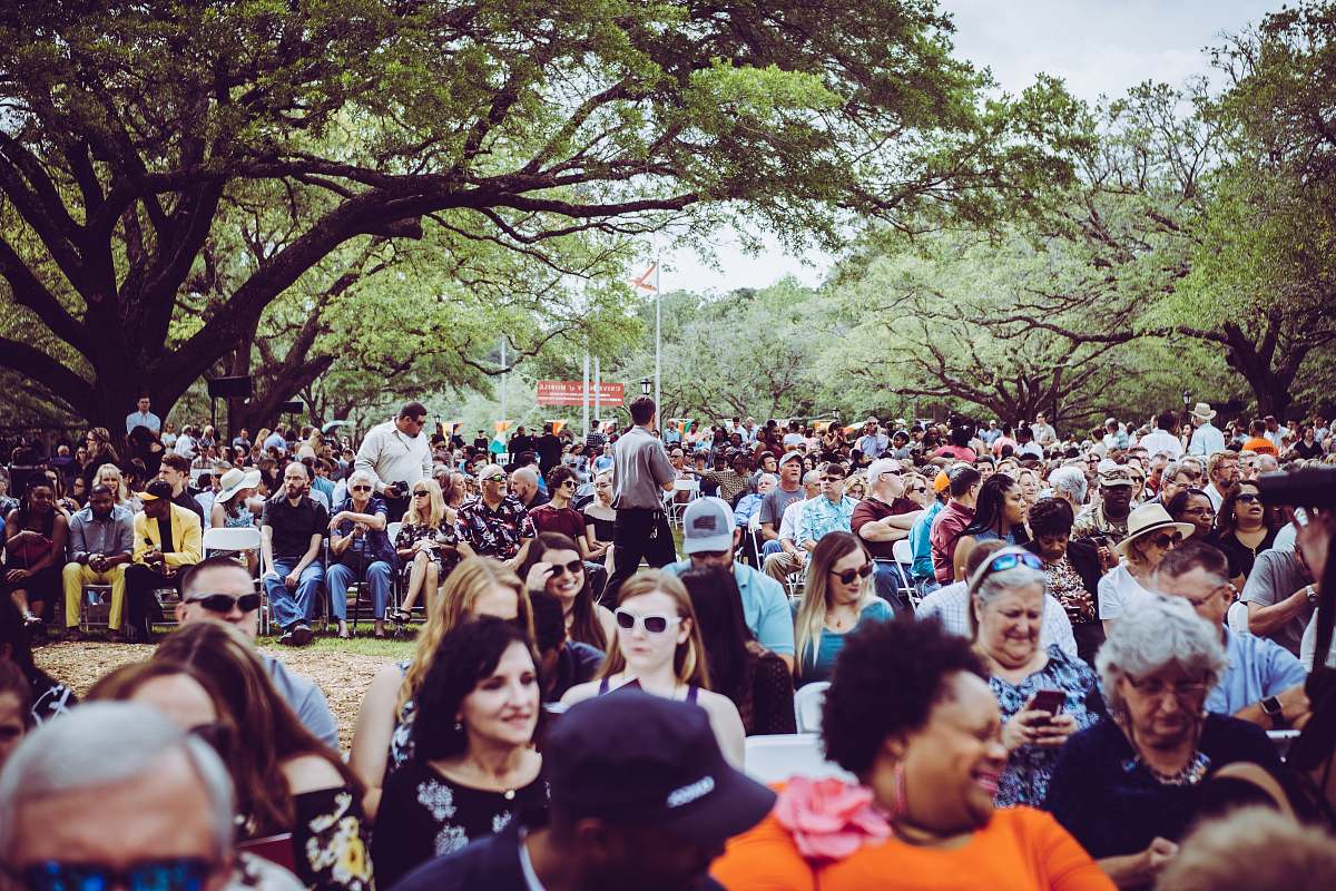 person person taking photo of man and woman crowd
