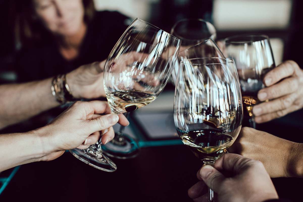 wine group of people holding footed glasses glass