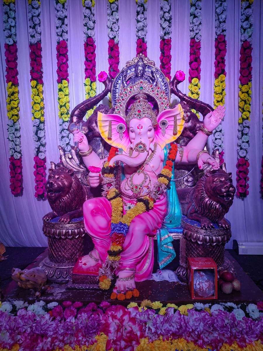 human Lord Ganesha sitting statue crowd