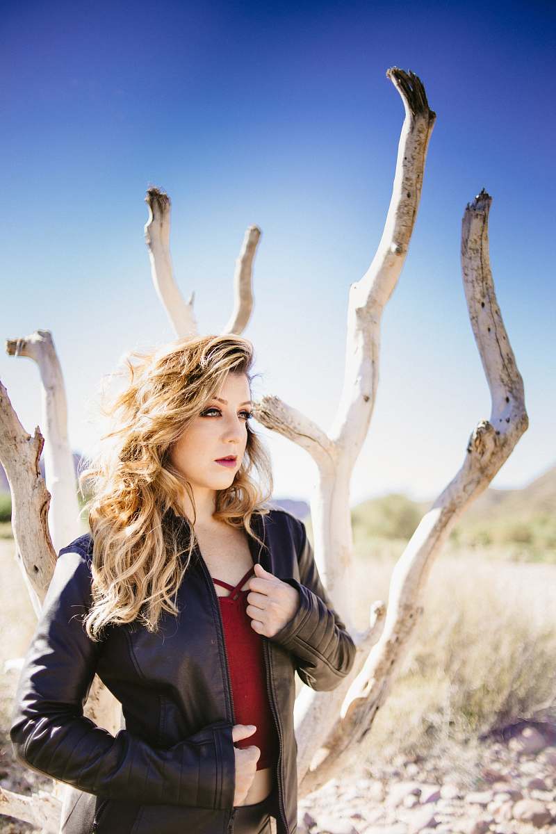 clothing woman standing beside bare-tree apparel