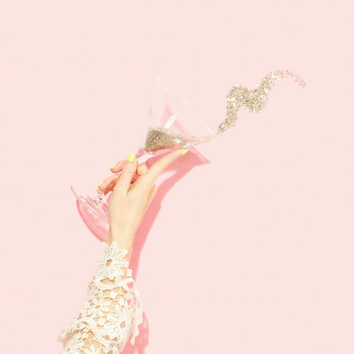 party person holding clear martini glass glitter