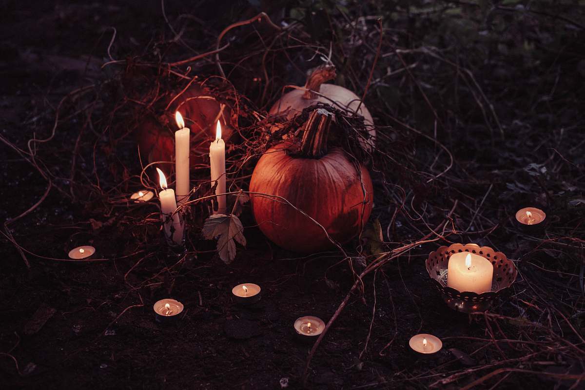 squash pumpkin between lighted candles halloween
