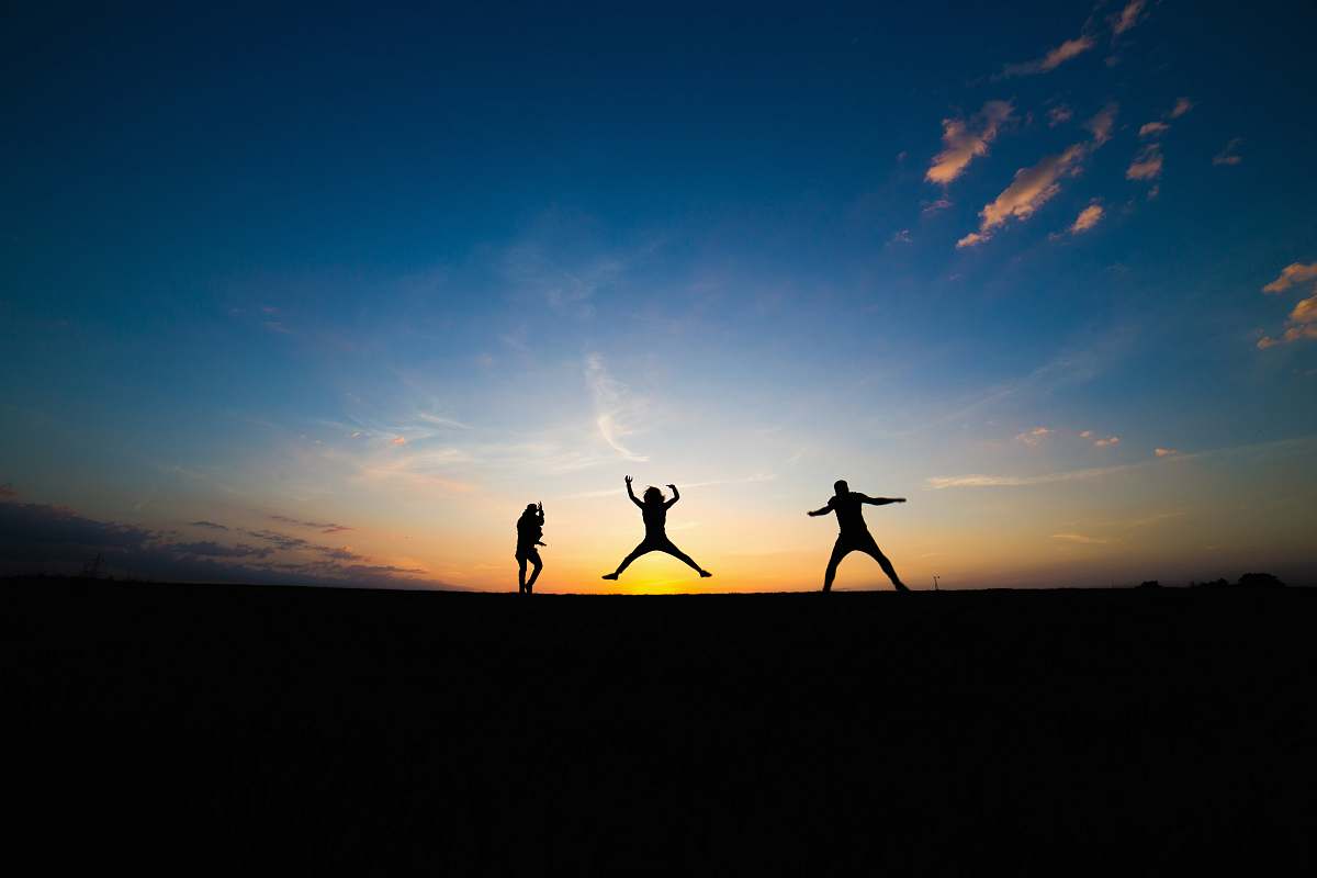 outdoors silhouette of three person jumping silhouette