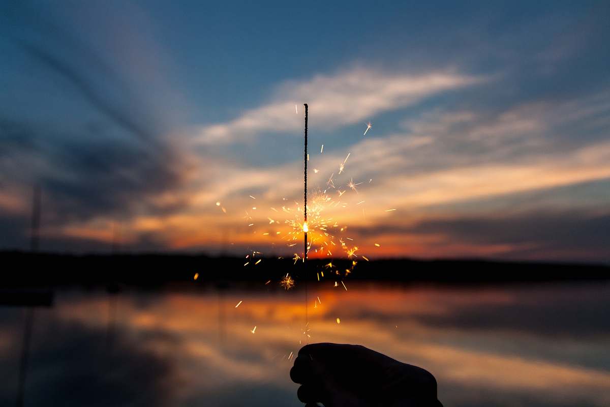 sky silhouette of person holding sparker sunrise