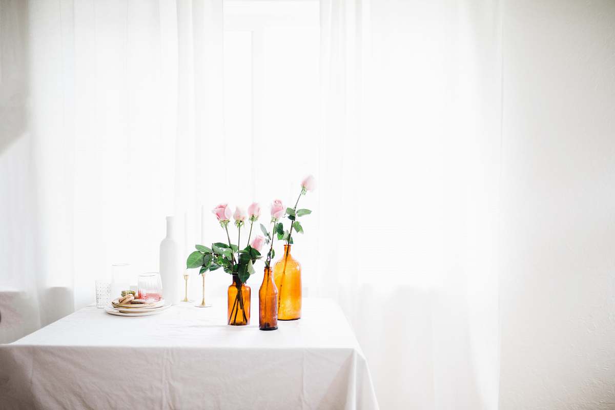 linen three amber glass flower vase with pink flowers on white table near window curtain home decor