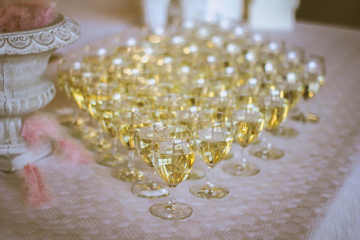 glass clear wine glass lot filled with yellow liquid wine