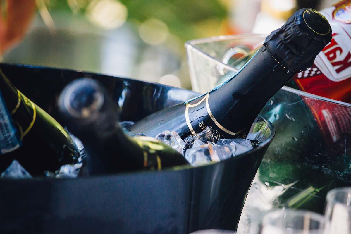 drink closeup photo of three wine bottles on bucket with ice bottle