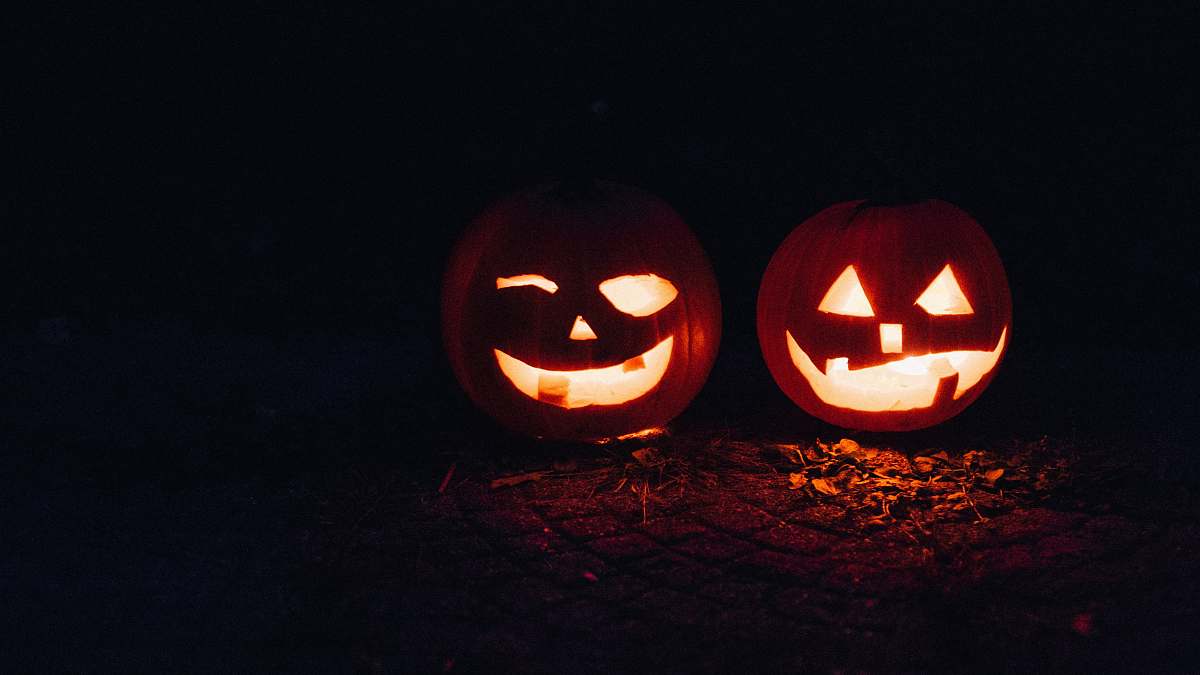  two lighted jack-o-lanterns during night time 