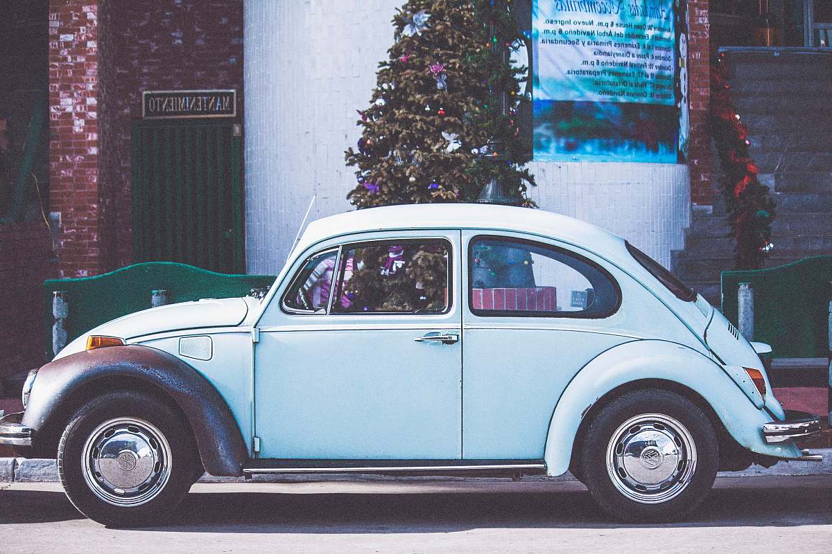  vintage white car near Christmas tree 