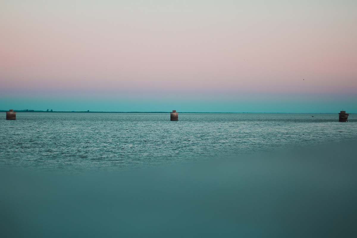 building calm sea under clear sky tower