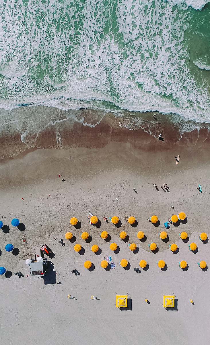 outdoors aerial photography of umbrellas on beach snow