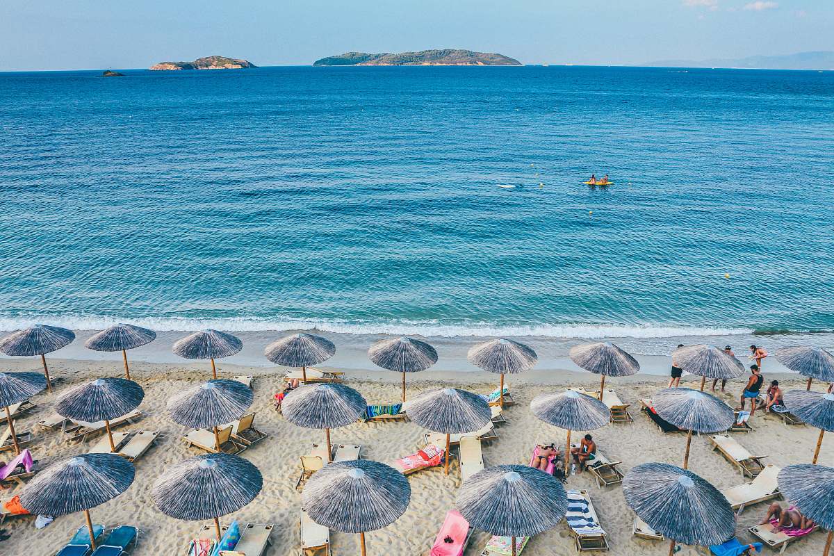 umbrella beach lounge on seashore facing the sea greece