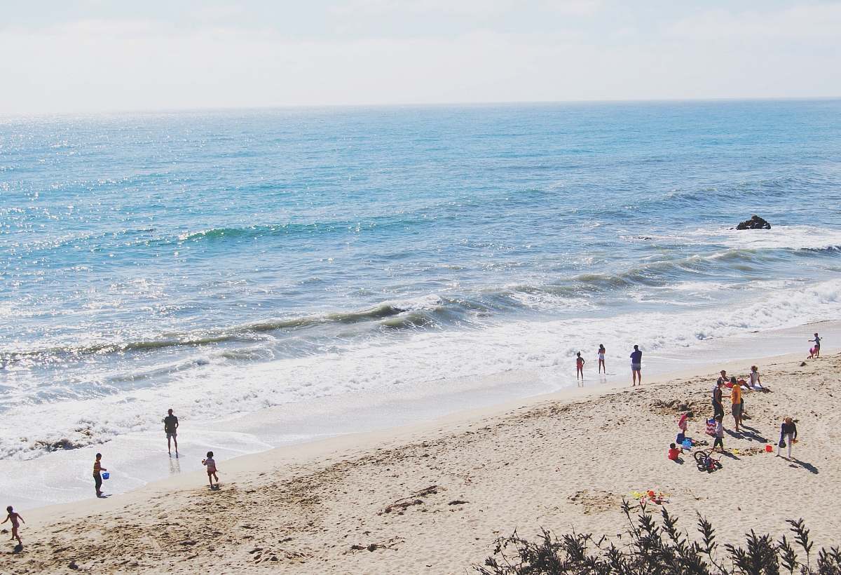 water group of people standing on seashore sea
