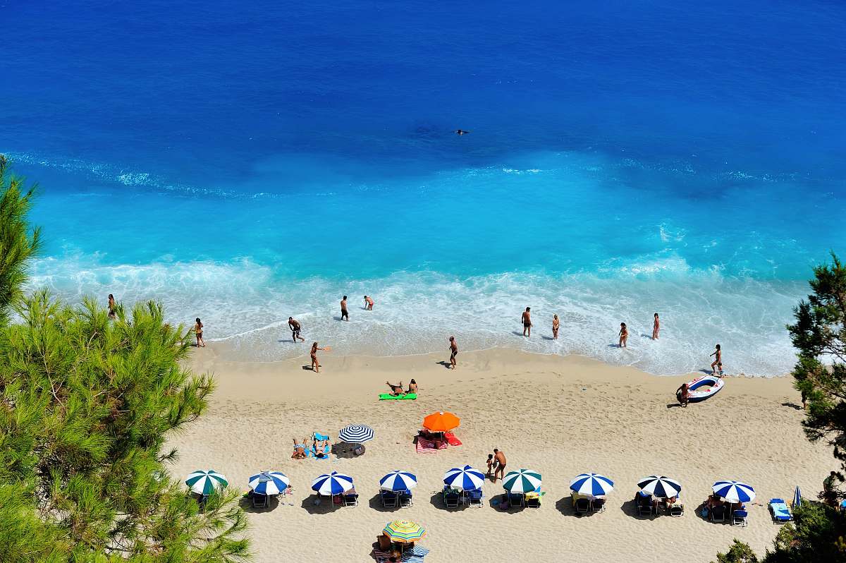 sea group of people swimming on beach greece