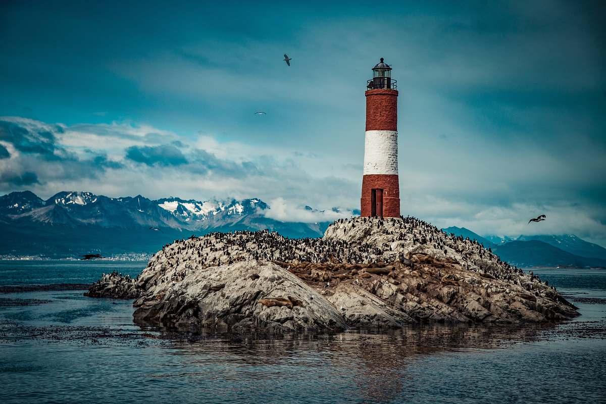 architecture red and white lighthouse near body of water tower