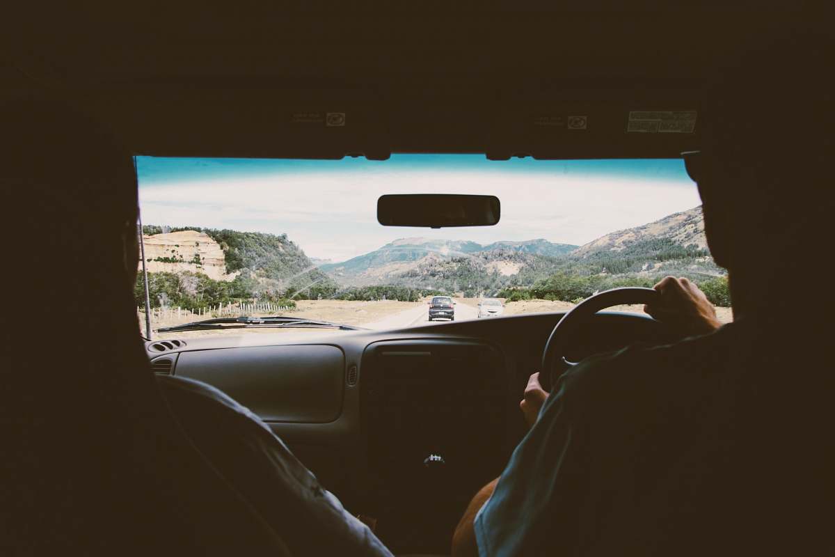 dashboard two person inside vehicle steering wheel
