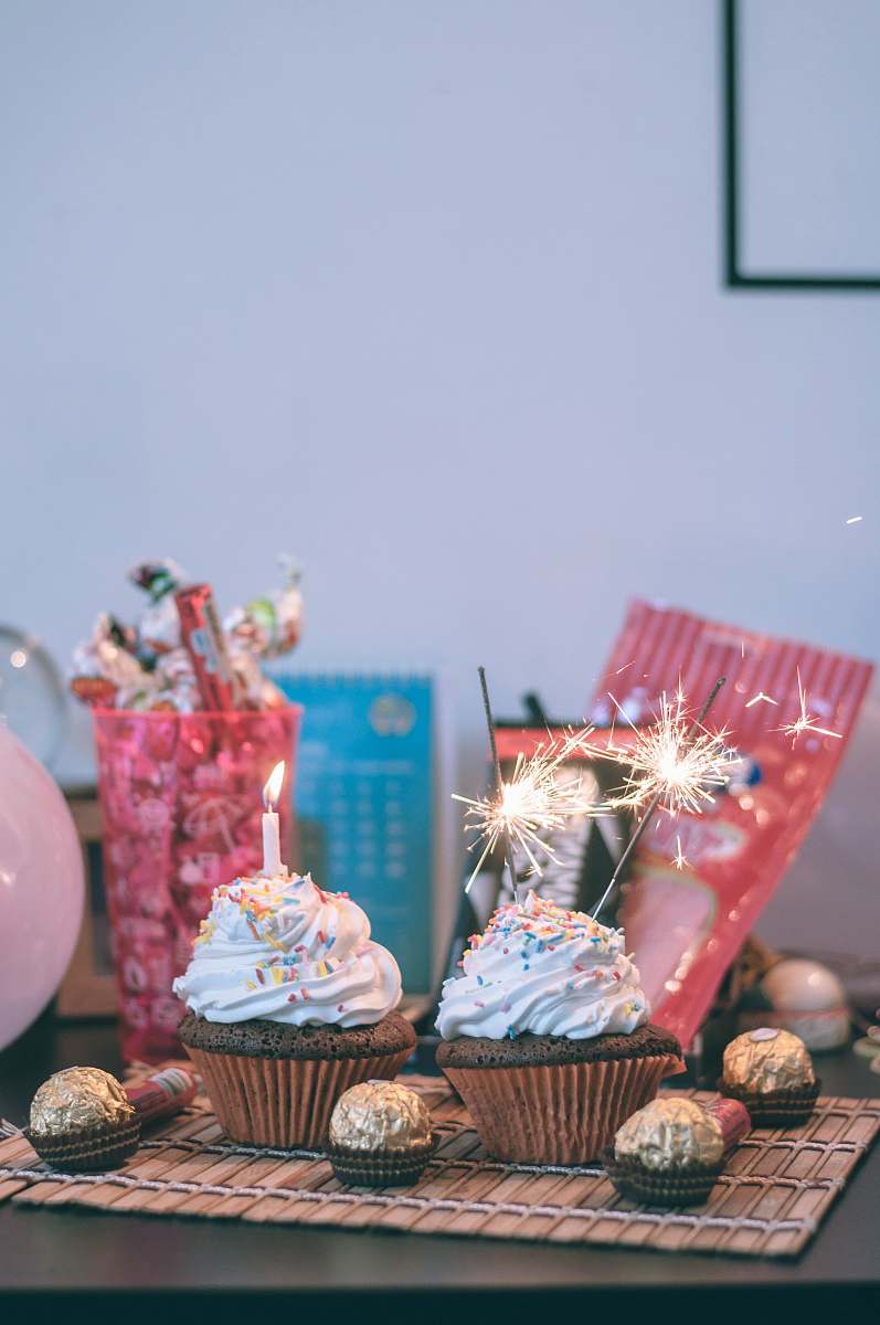 icing candles and sparkler on cupcakes cream
