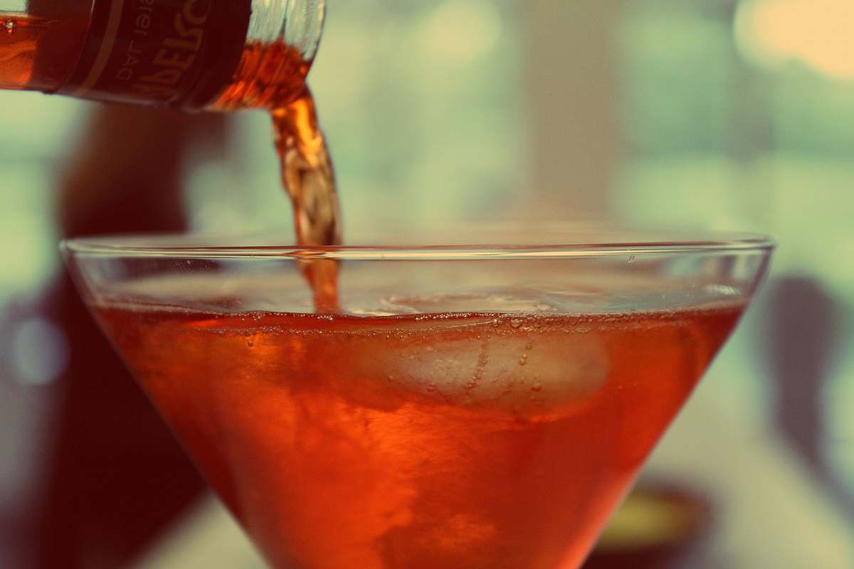 cocktail red liquid poured over clear martini glass alcohol