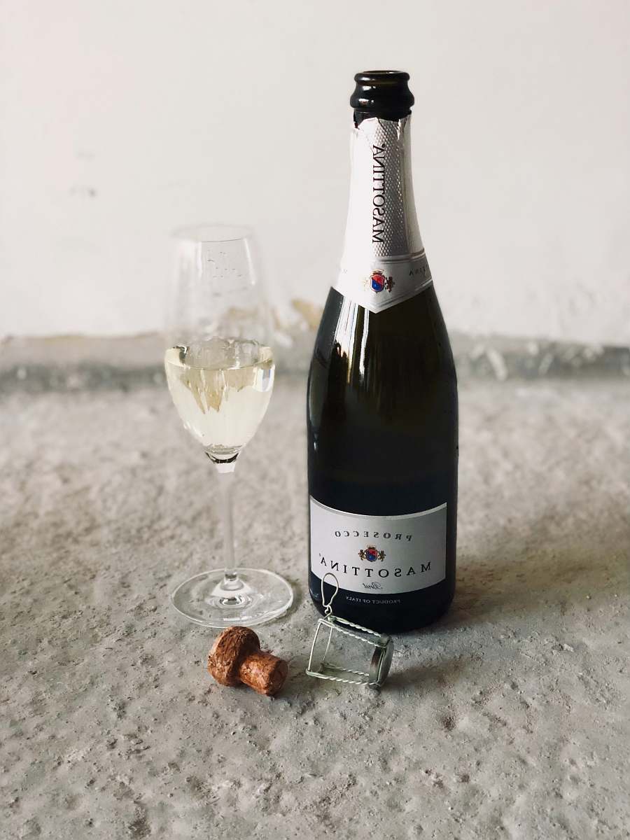 bottle black champagne bottle beside champagne flute drink