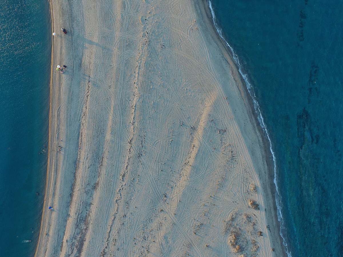 greece aerial view of white sand surrounded by body of water aerial