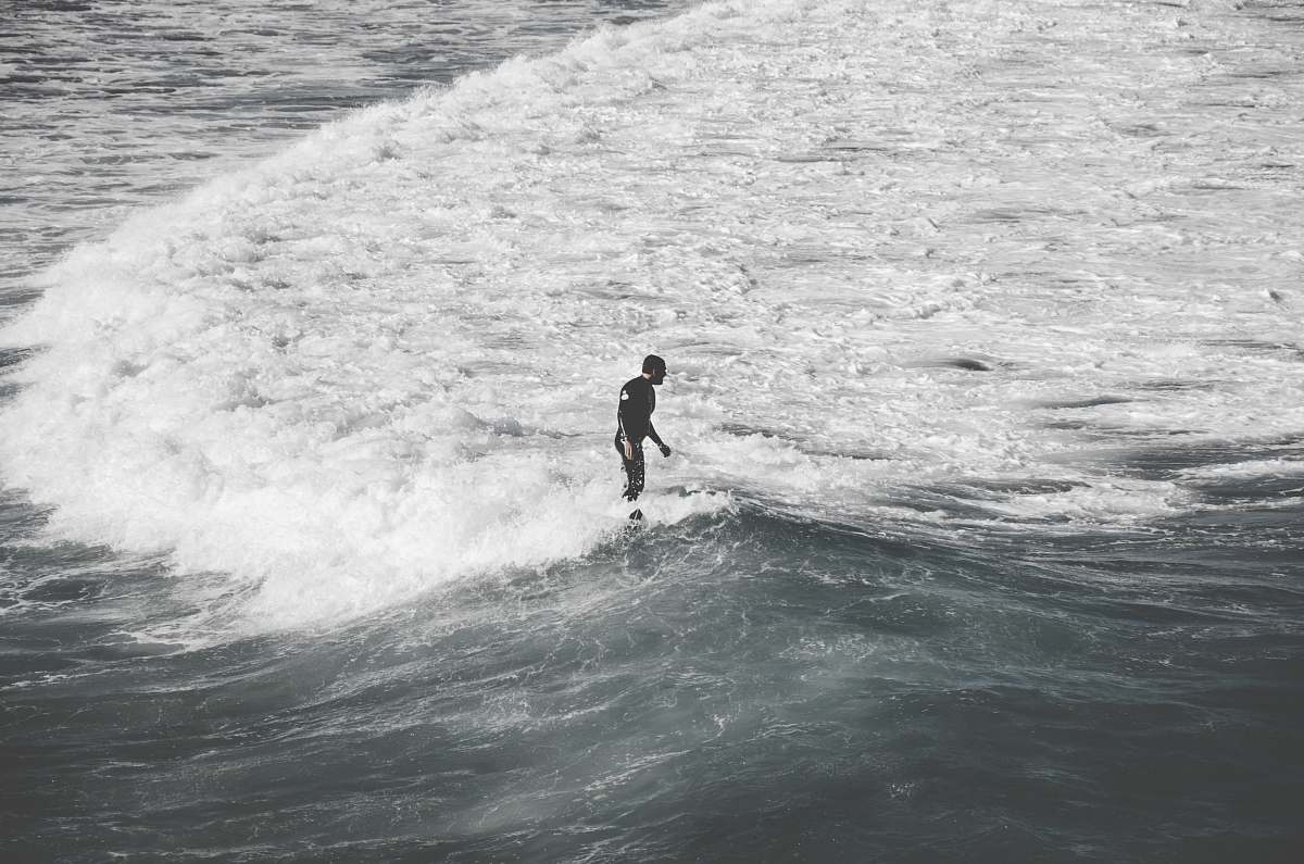 water man standing on sea shore with waves ocean