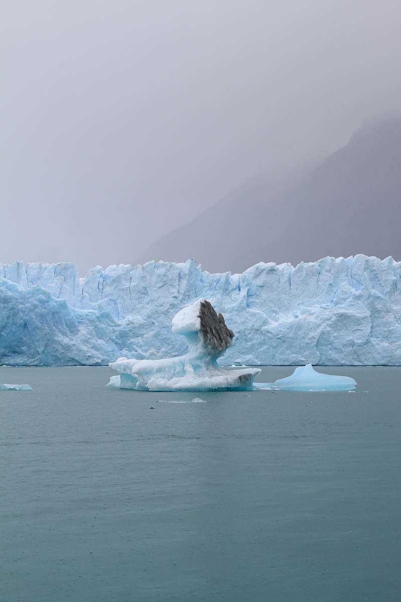 ice iceberg on body of water at daytime glacier