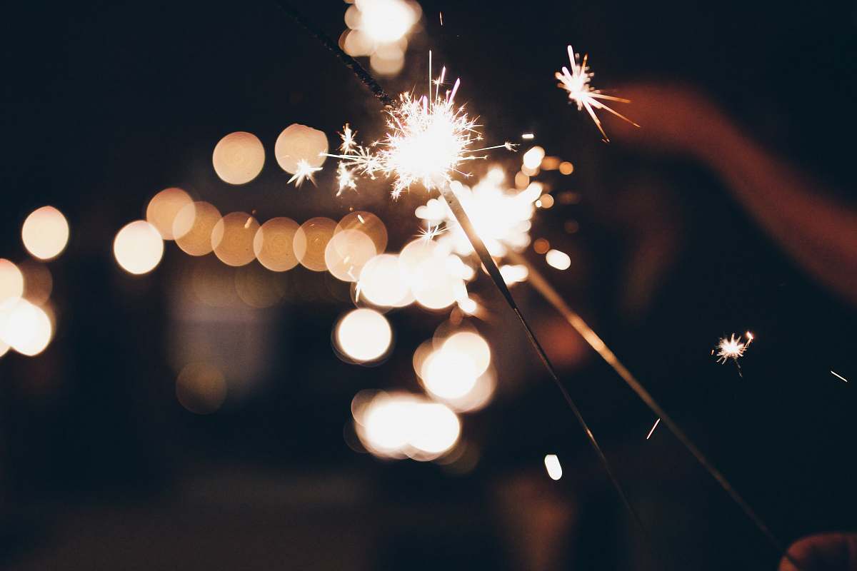 person bokeh photography of sparkler human
