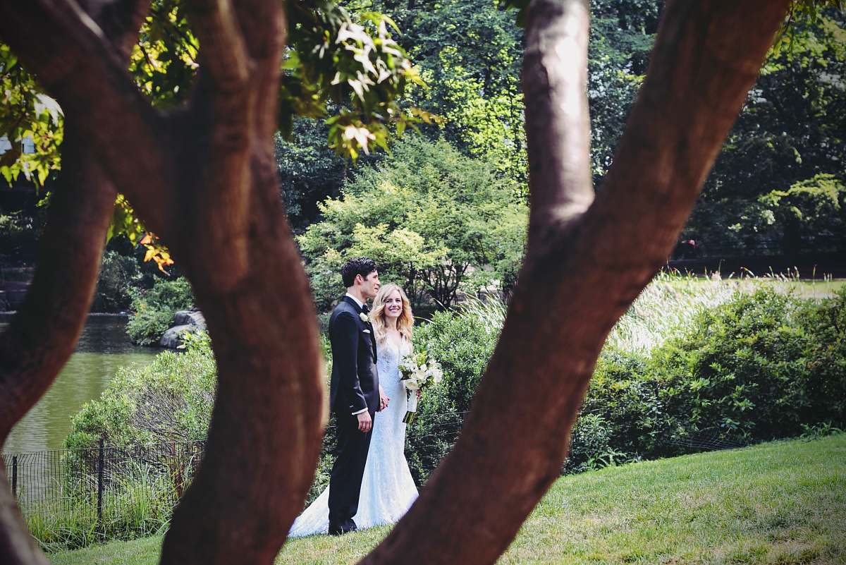 person man and woman standing on grass field near tree wedding day