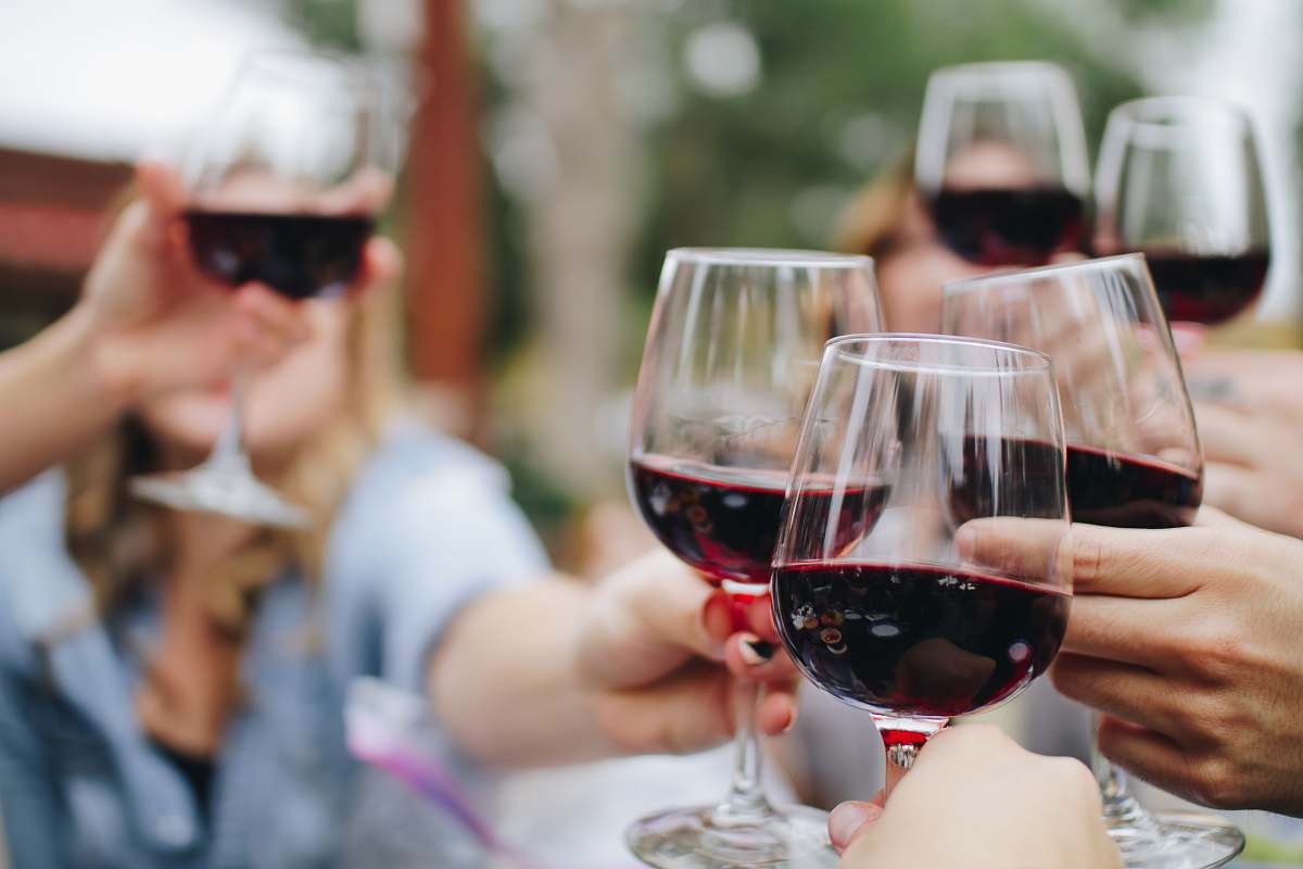 drink people tossing their clear wine glasses wine