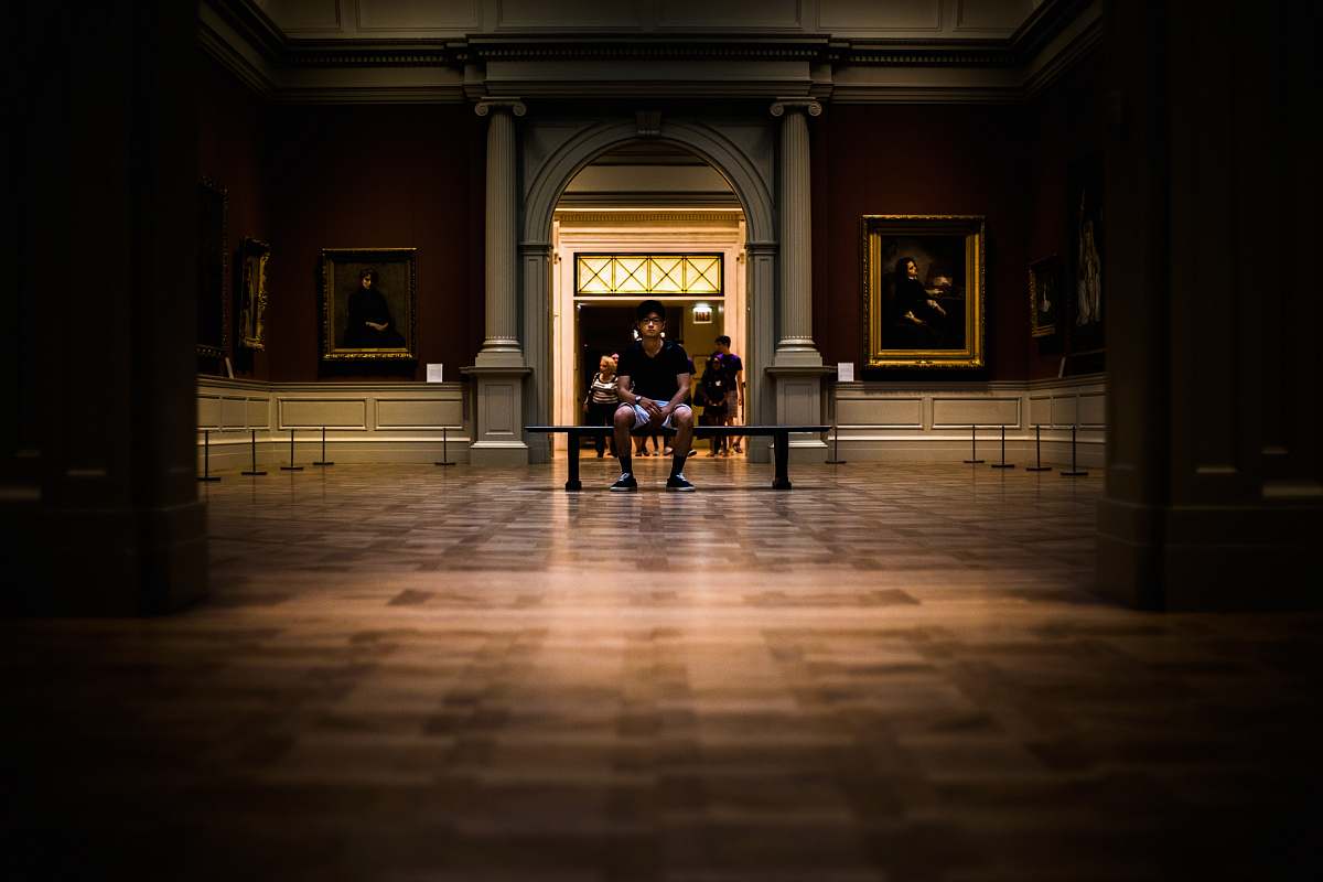 floor man sitting on bench on middle of house interior art