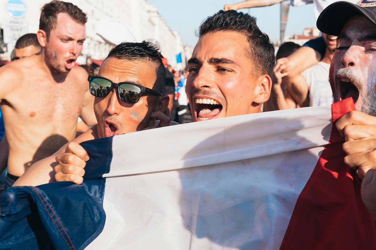 human men holding flag near people during day people