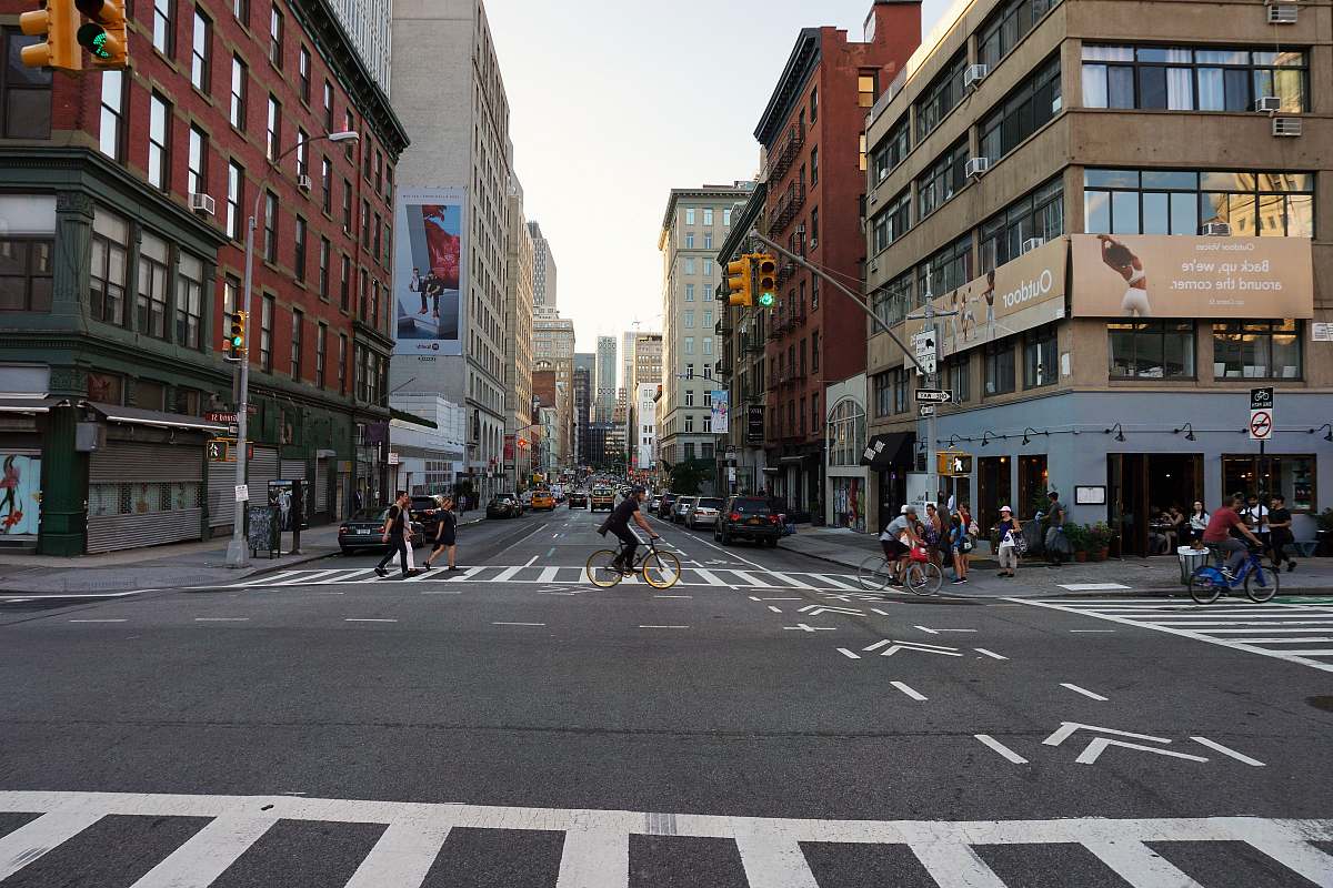asphalt man riding bicycle at middle of street tarmac