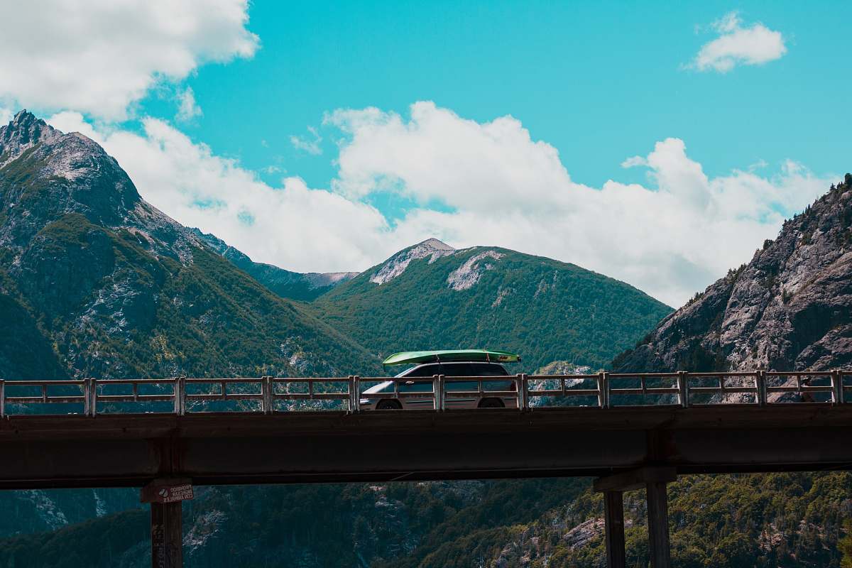 freeway silver van on gray bridge overpass