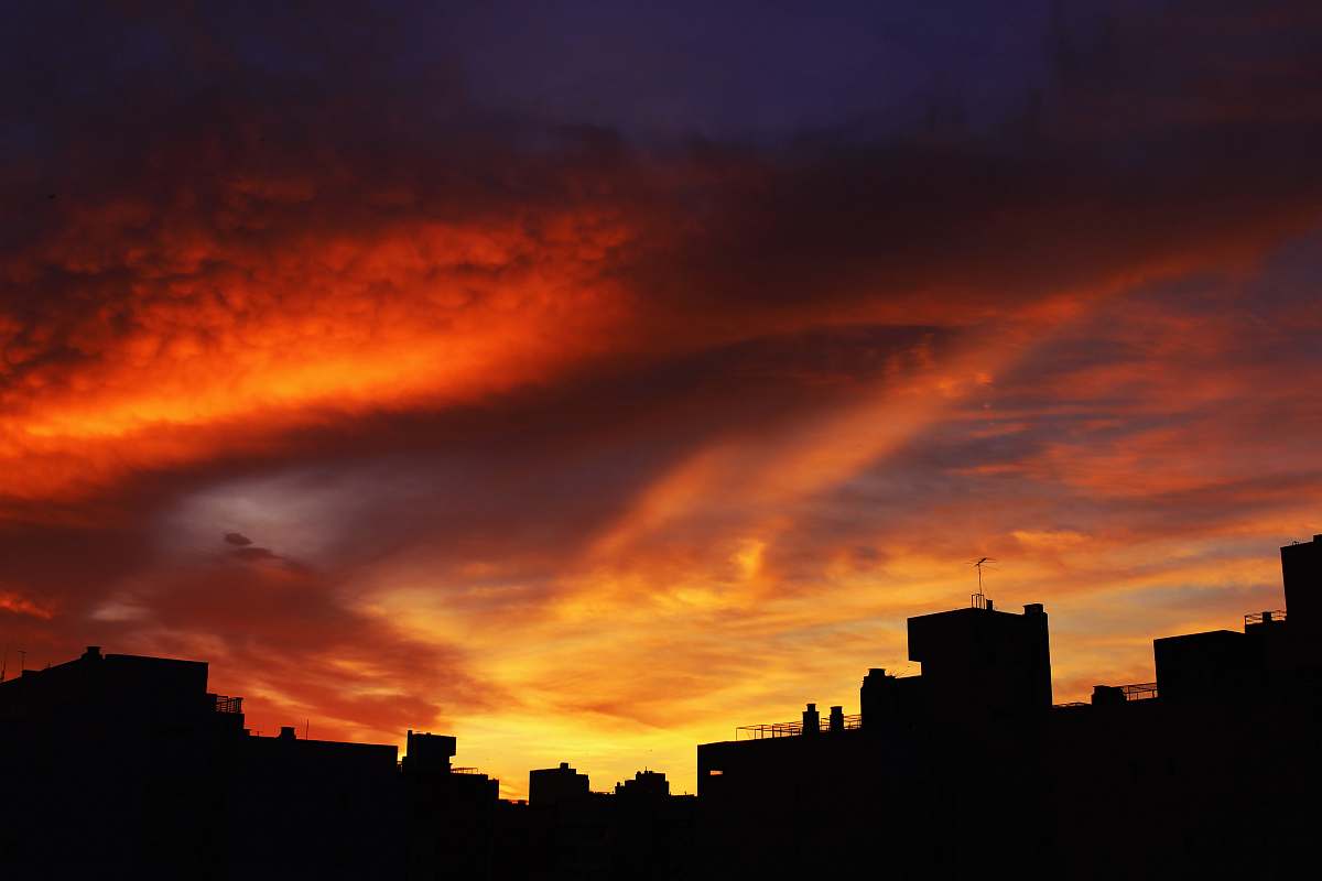 sunset silhouette of buildings under scarlet sky sunrise