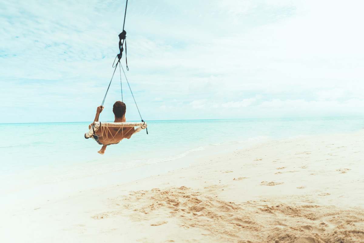 toy man swing beside body of water water
