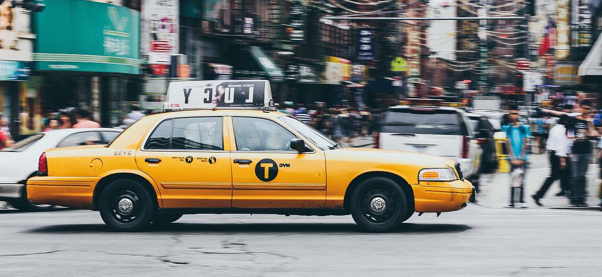 automobile yellow taxi on concrete road car